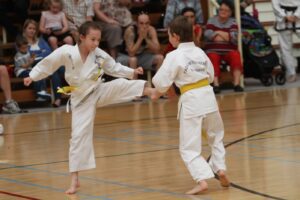 Boy and girl at Taekwondo class, sparring