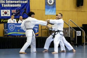 Luciano Favari breaking board with right hand forward punch