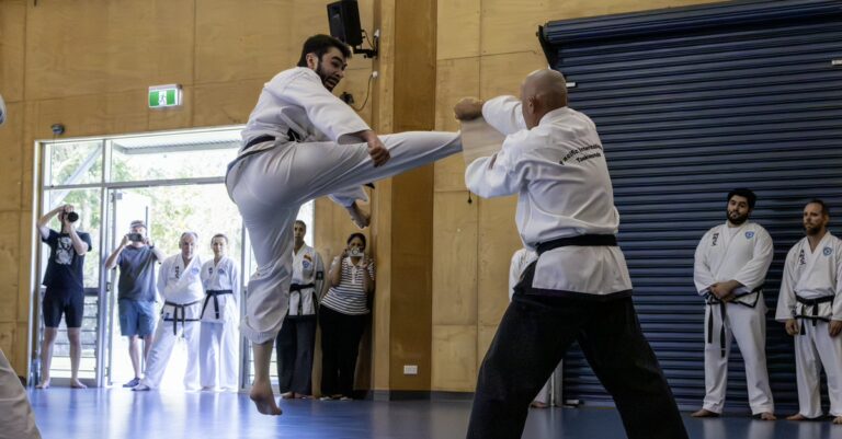 Huso Heric breaking a board with a flying kick