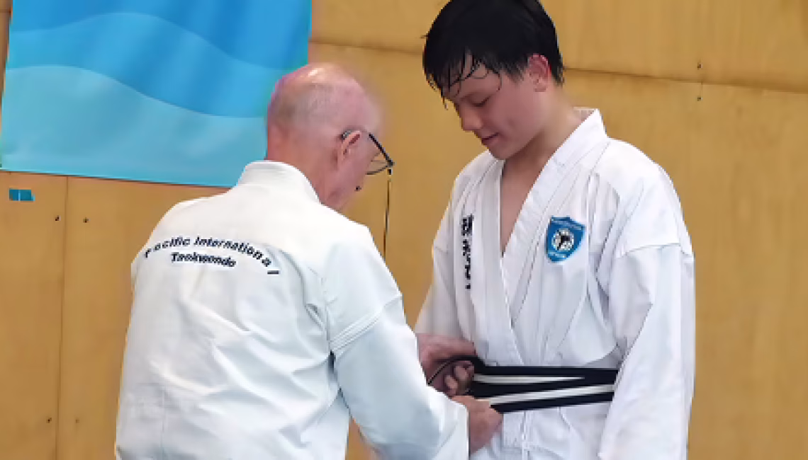 Harry Kerridge receiving junior Black Belt